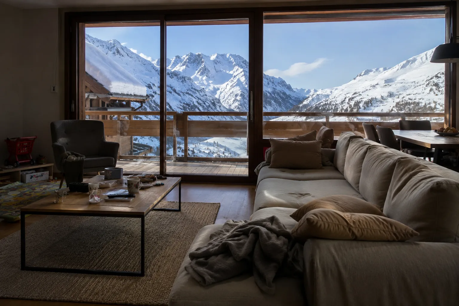 Illustration placeholder: bright Alpine apartment living room with moving boxes, winter jackets.